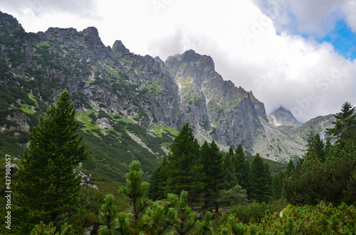Landscape with high stone sharp rocky peaks under cloudy sky in National Park High Tatras Mountains  Slovakia. Tourist destination for hiking and tourism