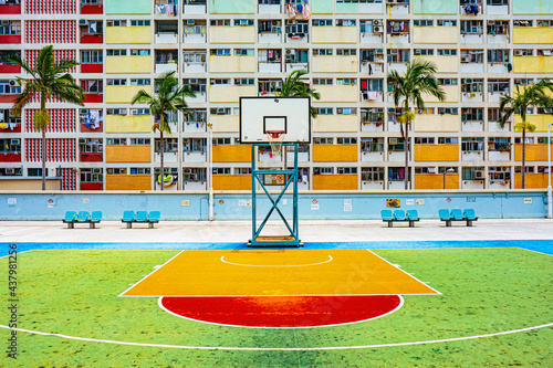 Colorful rainbow pastel building with basketball court and facade windows background in public park. Architecture building design in Choi Hung Estate, Kowloon, Hong Kong City, China