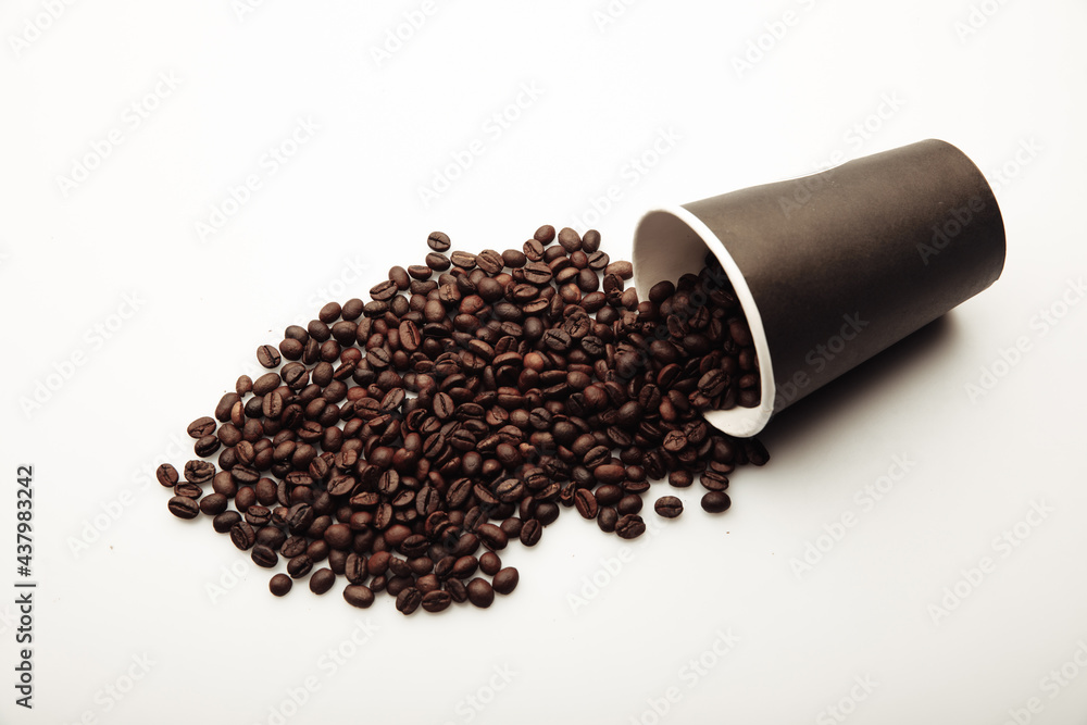 Cup of coffee full of coffee beans on white background Cup of coffee full of coffee beans on white background
