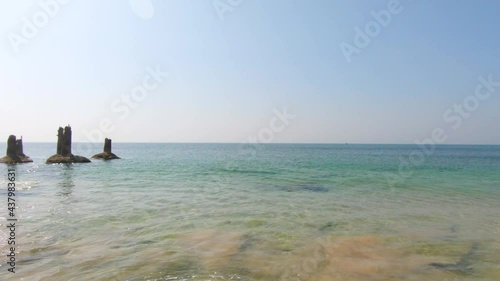 Scenic view of waves crashing on cliffs on rocky beach at Bechtel beach, Gujarat, India photo