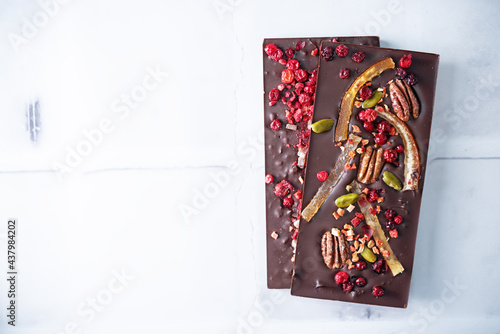 Handmade dark chocolate with berries and nuts photo