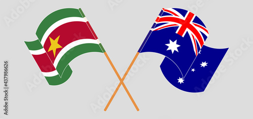Crossed and waving flags of Suriname and Australia