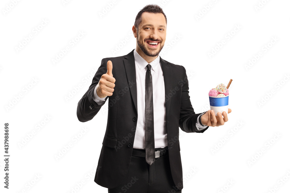 Businessman with ice cream in a paper cup showing thumbs up Businessman with ice cream in a paper cup showing thumbs up