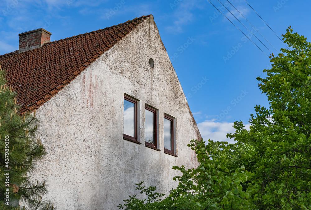 old country house with windows and tiled roof