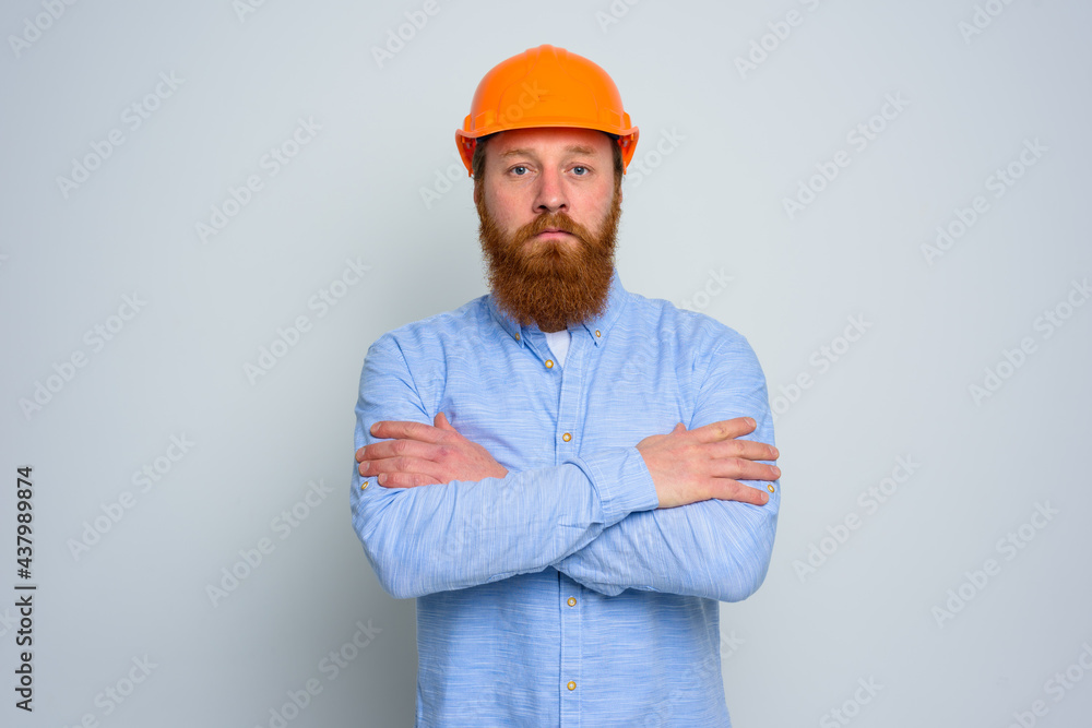 Isolated confidant architect with beard and orange helmet Isolated confidant architect with beard and orange helmet