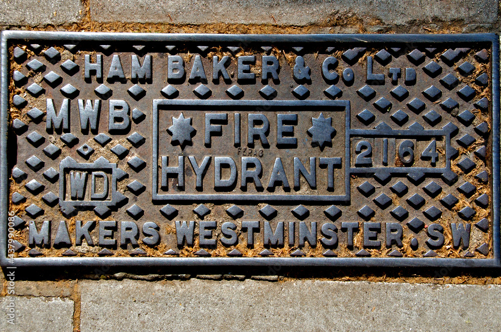 Cast iron fire hydrant cover from bygone era still in use today, London Stock Photo Adobe Stock