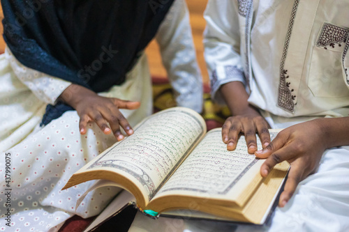 Photos Siblings studying and reciting the Quran