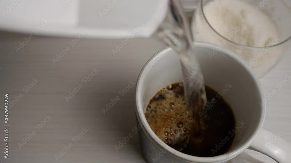 Making instant coffee.Hot water pouring into cup with instant coffee granules. Making instant coffee.Hot water pouring into cup with instant coffee granules.