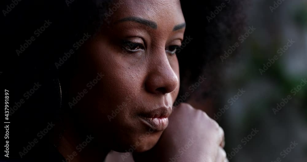 Sad pensive black woman close-up face feeling depressed and preoccupied Sad pensive black woman close-up face feeling depressed and preoccupied