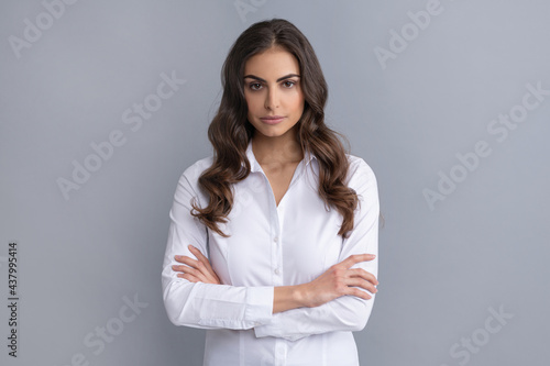 Serious confident business woman hold arms crossed grey, confidence