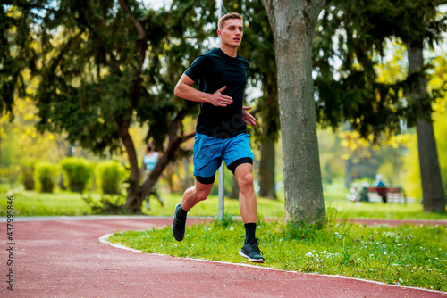 Young man jogging in park at morning Health and fitness