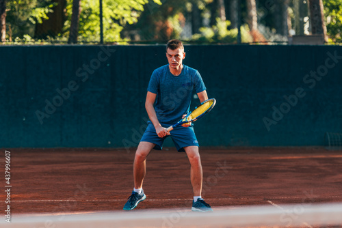 Focused male athlete waiting to receive the ball in a professional tennis game © qunica.com