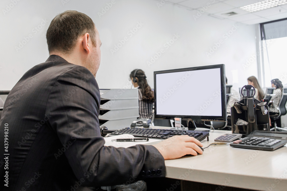 guy at the comp in the call center at the desk guy at the comp in the call center at the desk