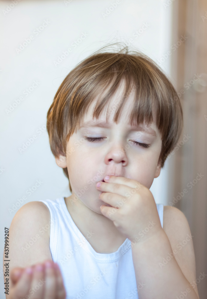 The boy eats a delicious berry and holds it in the palm of his hand. The pleasure of eating. Blueberries in the palms of the child. The boy eats a delicious berry and holds it in the palm of his hand. The pleasure of eating. Blueberries in the palms of the child.