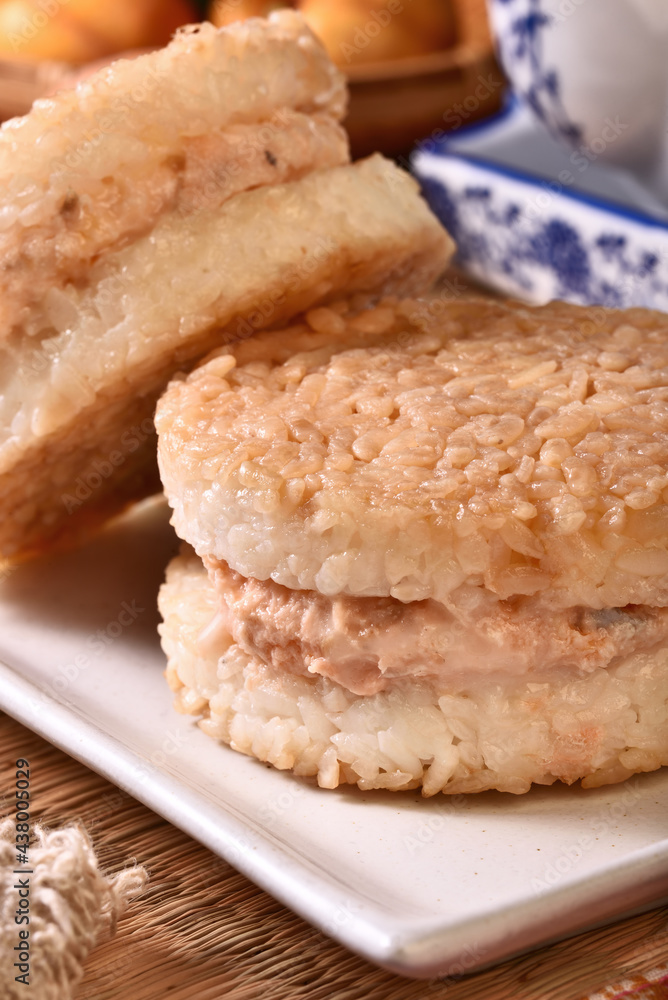 Rice burger with salmon, cheese on a white plate Rice burger with salmon, cheese on a white plate