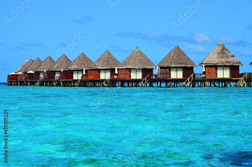 Line of water villas at a resort in Maldivian sea
