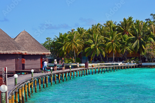 Long wood bridge over the sea leading to a resort in Maldives © surasak