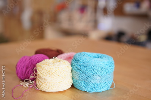 Crochet thread in group as many colors in studio of handicraft school as background. Needles craft on table for hand made hobby.Crochet yarn bag with cotton yarn.