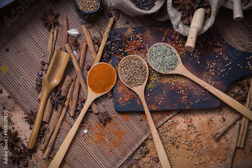 Spicy condiment, herbal aroma dry food for Asian cookin on wood  cutter with dry seed and colorful powder for kitchen ingredient photo