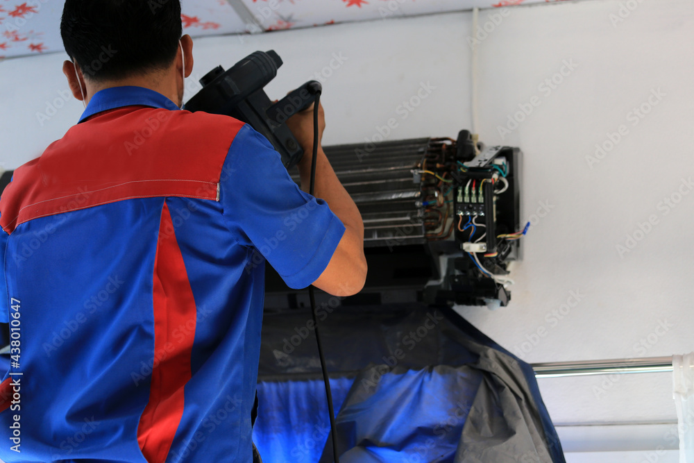 Fototapeta premium Fixing and cleanning coil and compressor of air conditioner by professional cleaner electrical machine repairman.