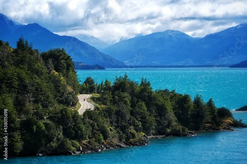 Cyclist's turquoise paradise Solo cyclist on the Carretera Austral along the turquoise General Carrera lake, Patagonia, Chile