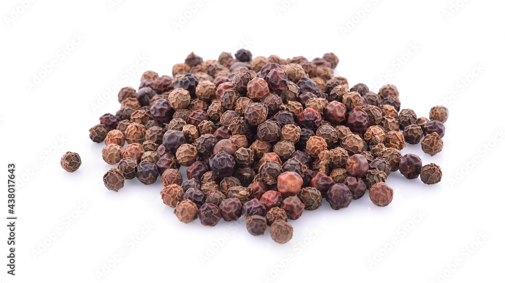 black peppercorns on a white background black peppercorns on a white background