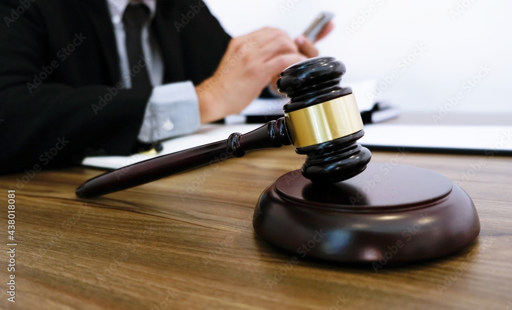Lawyer Legal counsel presents to the client a signed contract with gavel and legal law. justice and lawyer Business partnership meeting concept. Lawyer Legal counsel presents to the client a signed contract with gavel and legal law. justice and lawyer Business partnership meeting concept.