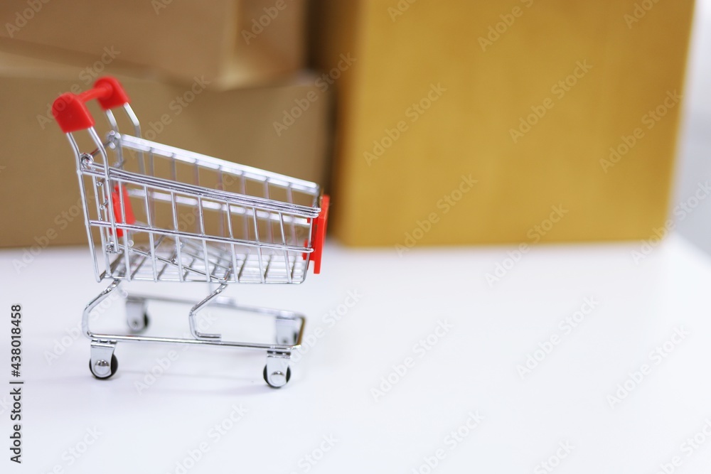 Small shopping cart for Internet online shopping e-commerce online delivery serviceconcept Small shopping cart for Internet online shopping e-commerce online delivery serviceconcept