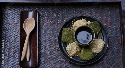 Warabi mochi, japanese soft glutinous rice with sweet sticky sauce for dipping wth cake. Green tea and Hojicha mochi. photo