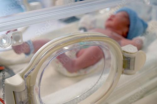 A newborn child infant asleep in the blanket delivery room in hospital