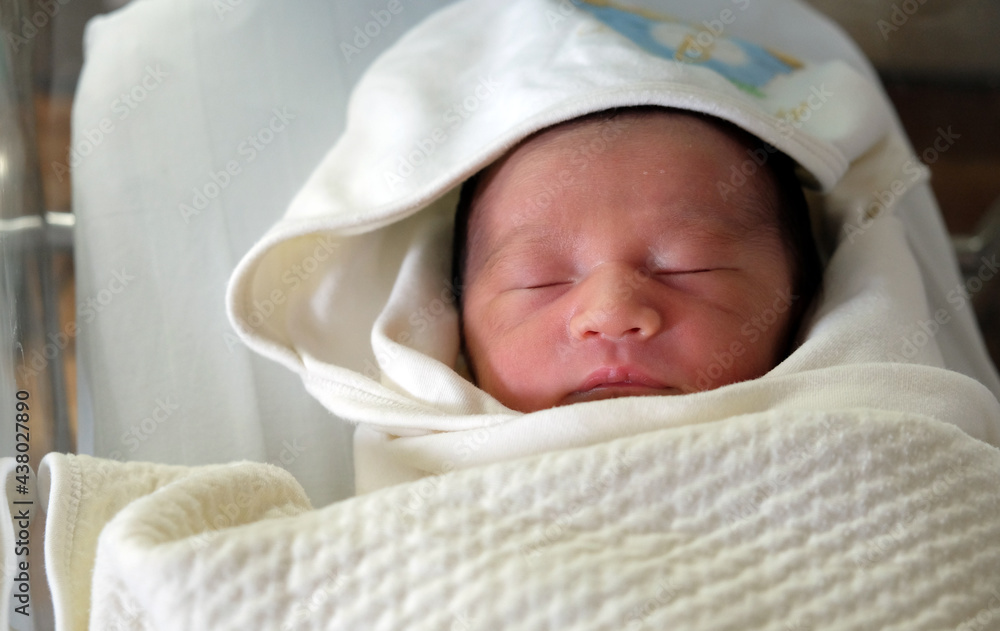 beautiful new born cute infant asleep in the blanket in delivery room beautiful new born cute infant asleep in the blanket in delivery room
