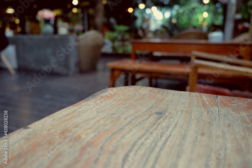 wood table on blur of cafe  coffee shop  bar  resturant  background - can used for display or montage your products