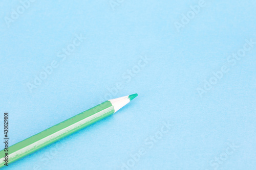 Colorful pencils on blue background