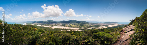Ultra wide panoramic landscape of the Ingleses and Mocambique dunes on a wonderful sunny day at Florianopolis, blue sky and mountains in the background. View from the top of Morro das aranhas. 
