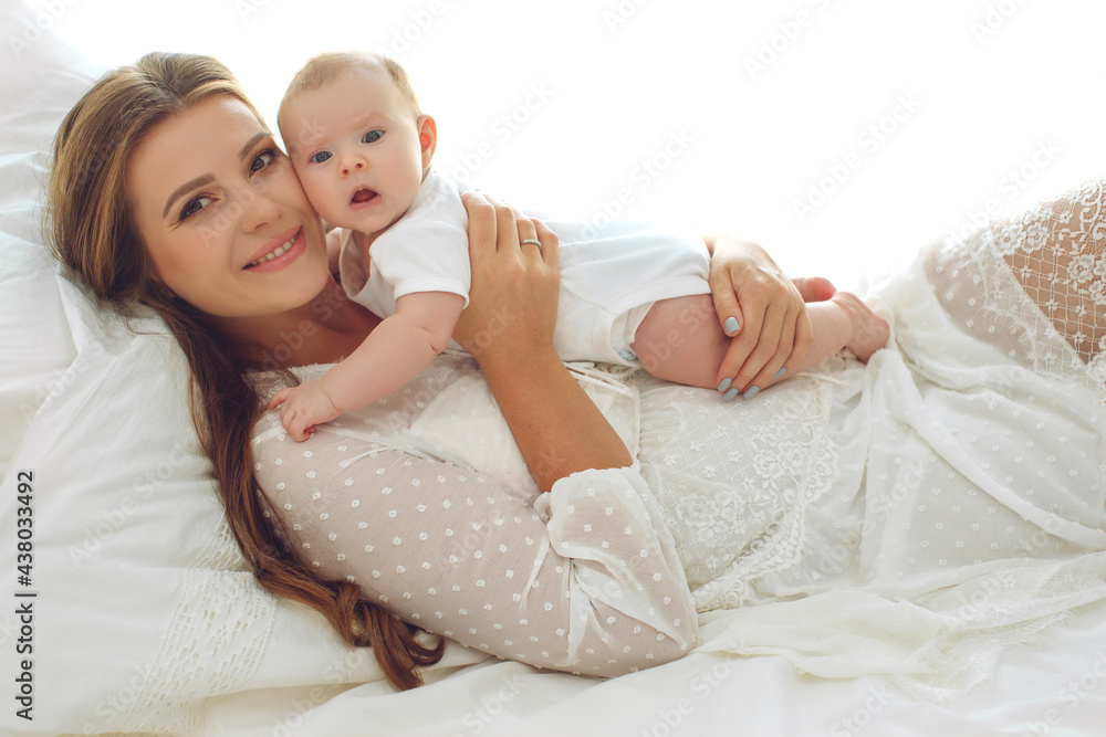 Portrait of a beautiful mother, with her nursing baby. High quality photo. Portrait of a beautiful mother, with her nursing baby. High quality photo.