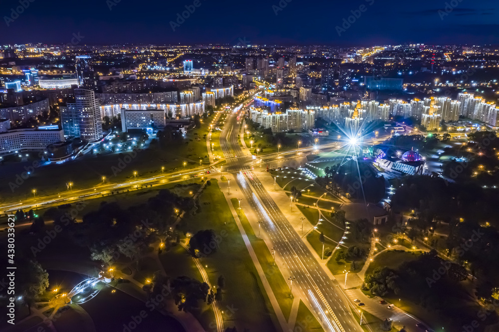 night cityscape with illuminated buildings and streets in Minsk city, Belarus. aerial view.