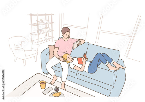 A couple is reading a book while sitting or lying on the sofa in the living room. hand drawn style vector design illustrations. 