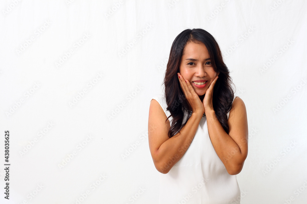 Beautiful young Asian girl smiling sweetly at the camera, putting her palm on her chin. Isolated on white background Beautiful young Asian girl smiling sweetly at the camera, putting her palm on her chin. Isolated on white background