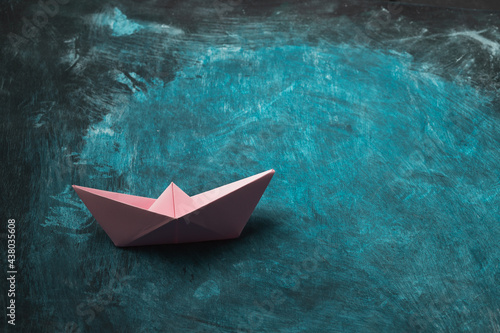leadership concept a paper boat that represents teamwork. © Treecha