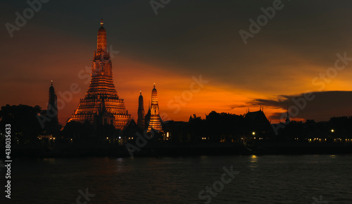 View of beautiful Wat Arun Rajvararam or Wat Arun or Wat Makok at waterfront of the Chao Phraya River in twilight,Which is historical significance and famous tourist destination of Bangkok,Thailand.