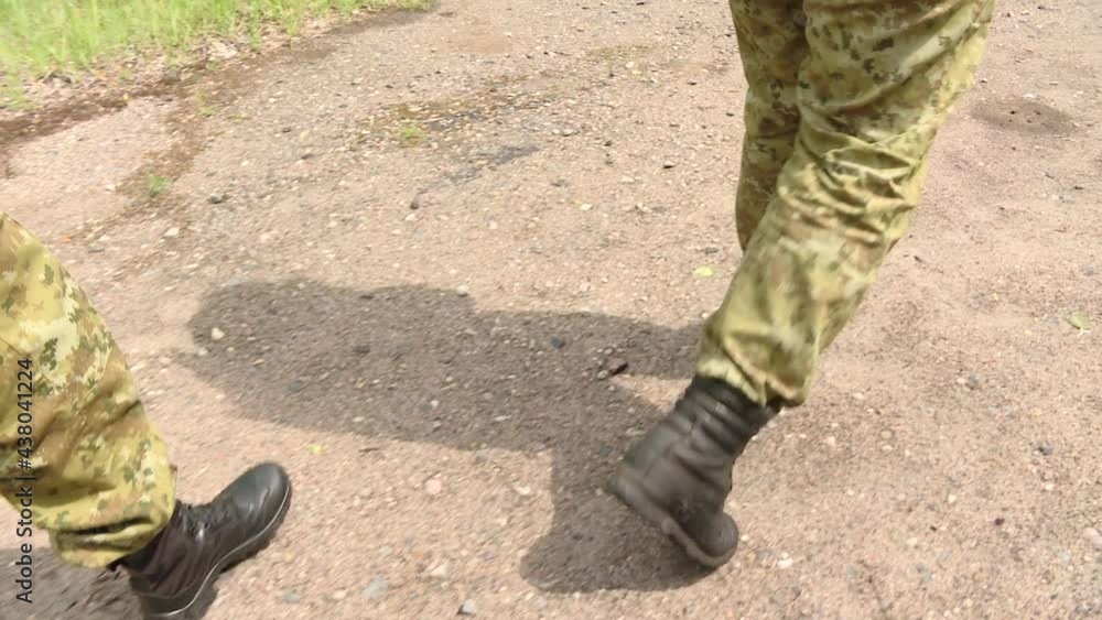 Legs of army soldiers walking along a dirt road. Persons under the obligation of military service (private and private) and those who joined the armed forces by special laws
Legs of army soldiers walking along a dirt road. Persons under the obligation of military service (private and private) and those who joined the armed forces by special laws