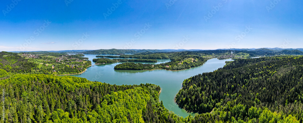 Wide Panorama of Solina Lake and Green Spruce tree Forest. Aerial Drone View