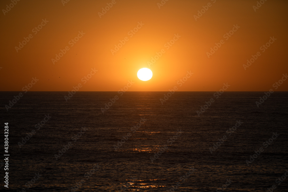Seascape golden sunrise over the sea. Nature landscape. Beautiful orange and yellow color on ocean sunset. Seascape with gold sky and clouds.