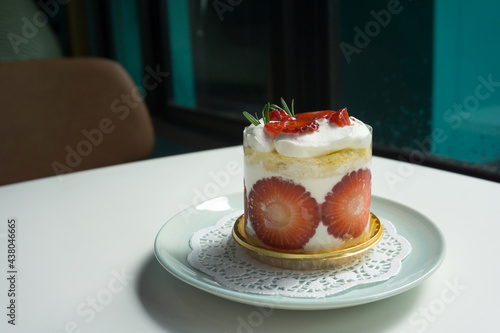 Valokuvatapetti Strawberry shortcake with rosemary leaf in cafe