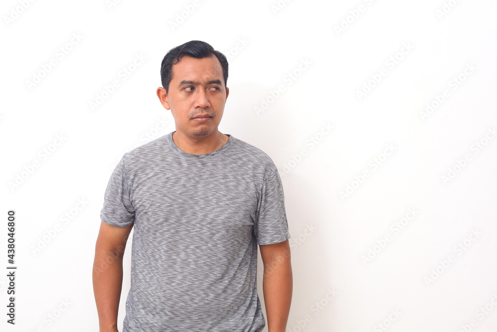 Portrait of Asian man with blank expression looking to the side. Isolated on white with copyspace Portrait of Asian man with blank expression looking to the side. Isolated on white with copyspace