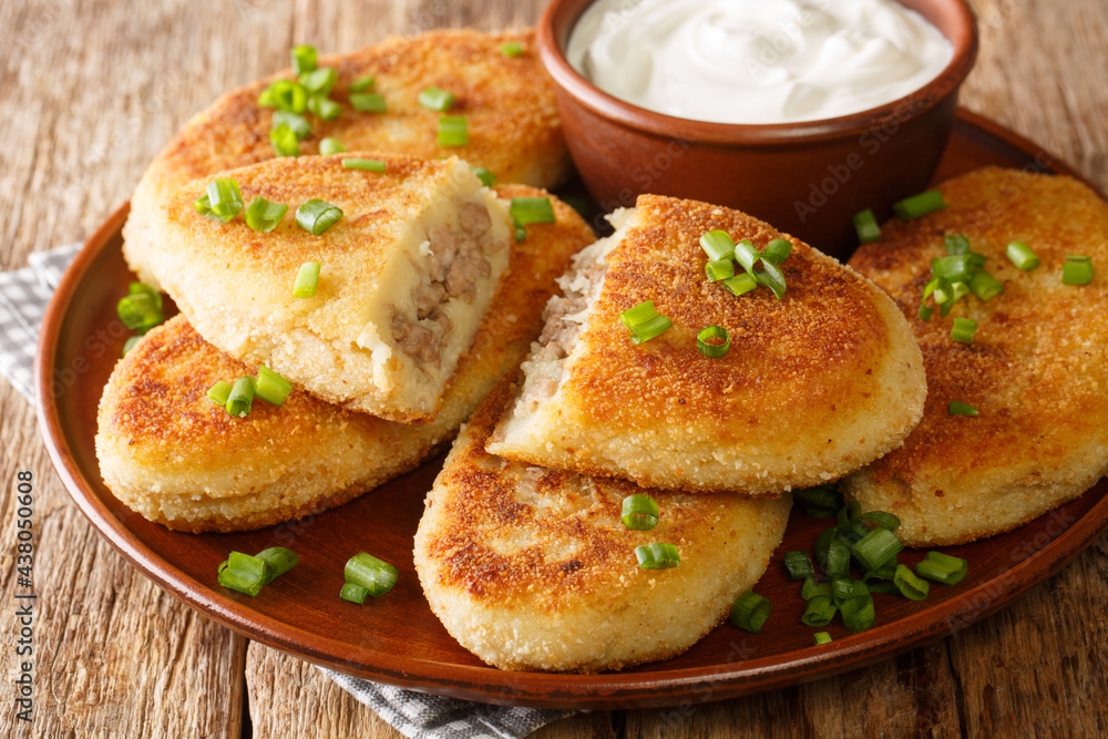 Traditional Ukrainian cuisine tasty Potato zrazy with meat close-up in a plate on the table. Horizontal Traditional Ukrainian cuisine tasty Potato zrazy with meat close-up in a plate on the table. Horizontal