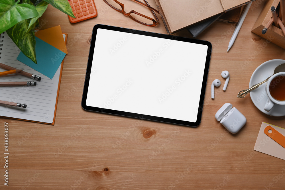 Mock up digital tablet with empty screen ad wireless earphone on wooden background. Mock up digital tablet with empty screen ad wireless earphone on wooden background.