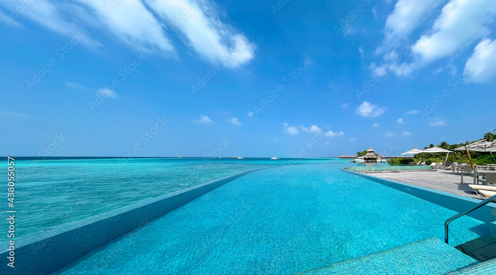 Scenic landscape of Maldives beach and pier with speed boats and yachts on the horizon. Seascape with water bungalows, beautiful turquoise sea and lagoon waters, tropical nature paradise. Scenic landscape of Maldives beach and pier with speed boats and yachts on the horizon. Seascape with water bungalows, beautiful turquoise sea and lagoon waters, tropical nature paradise.