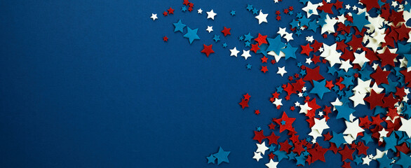 4th of July American Independence Day stars decorations on blue background. Flat lay, top view.