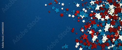 4th of July American Independence Day stars decorations on blue background. Flat lay, top view. photo